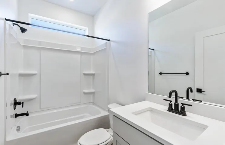 Bathroom with vanity and shower combination