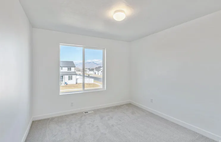 Upstairs 4th room featuring baseboards and light colored carpet
