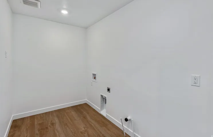 Laundry room featuring hookup for a washing machine, wood finished floors, and hookup for an electric dryer