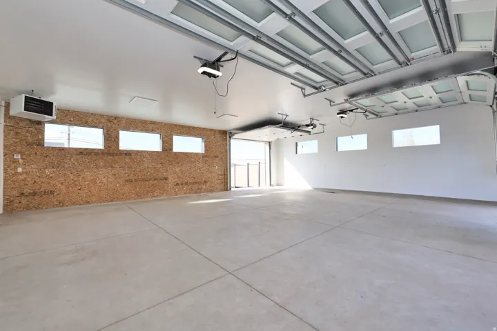 Garage featuring a heating unit