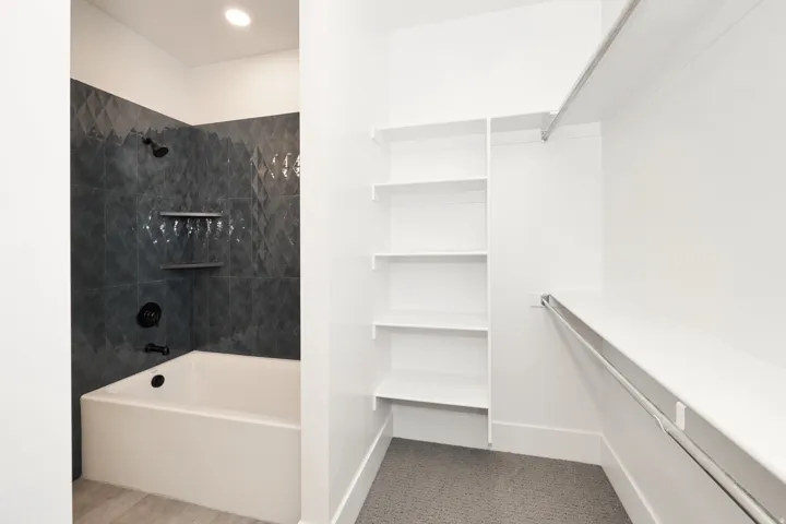 Full bathroom with tub / shower combination and baseboards