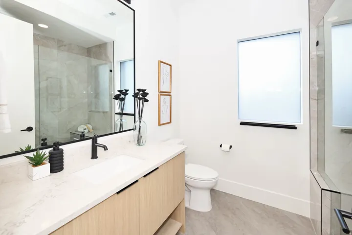 Bathroom with walk in shower, vanity, and recessed lighting