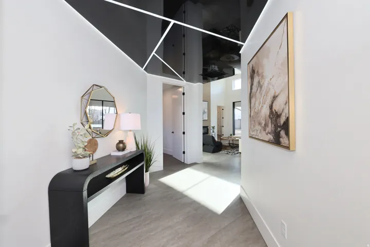 Hallway with a high ceiling and light wood-style floors