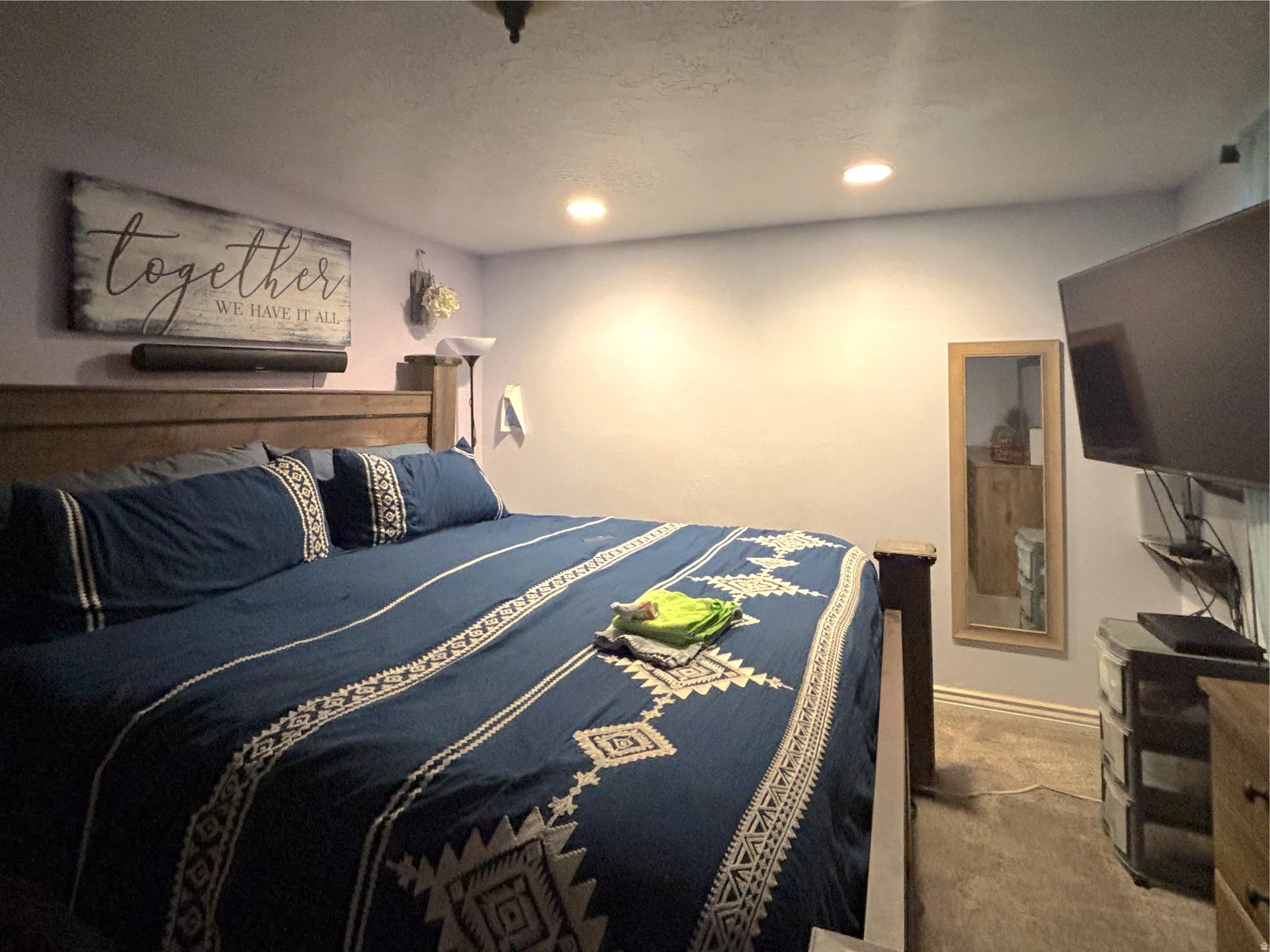 Bedroom with carpet flooring, recessed lighting, and a textured ceiling