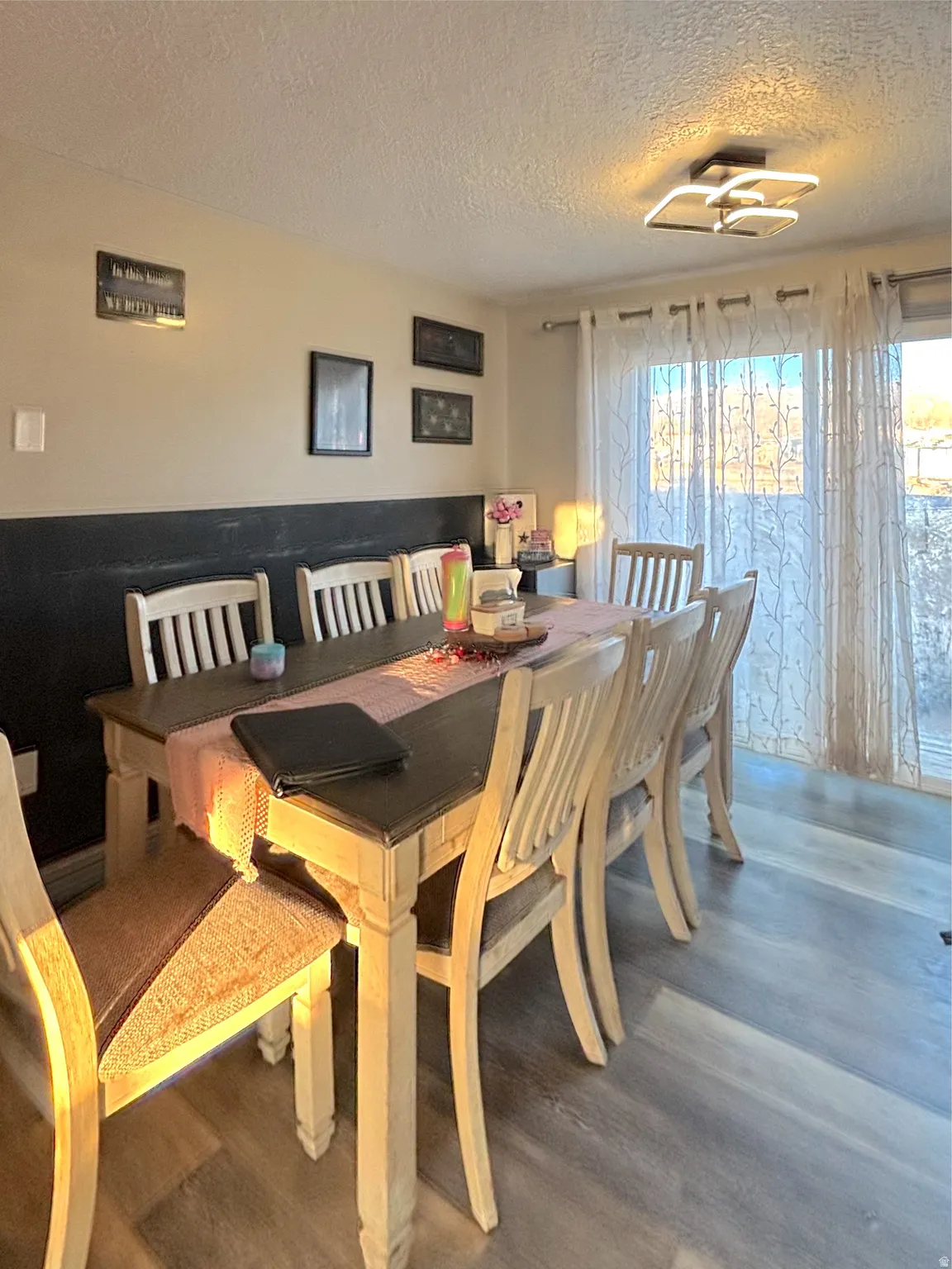Dining area featuring a textured ceiling, healthy amount of natural light.