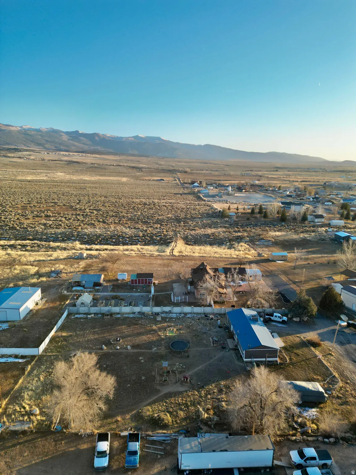 Overview of rural landscape with a mountain backdrop and a desert landscape