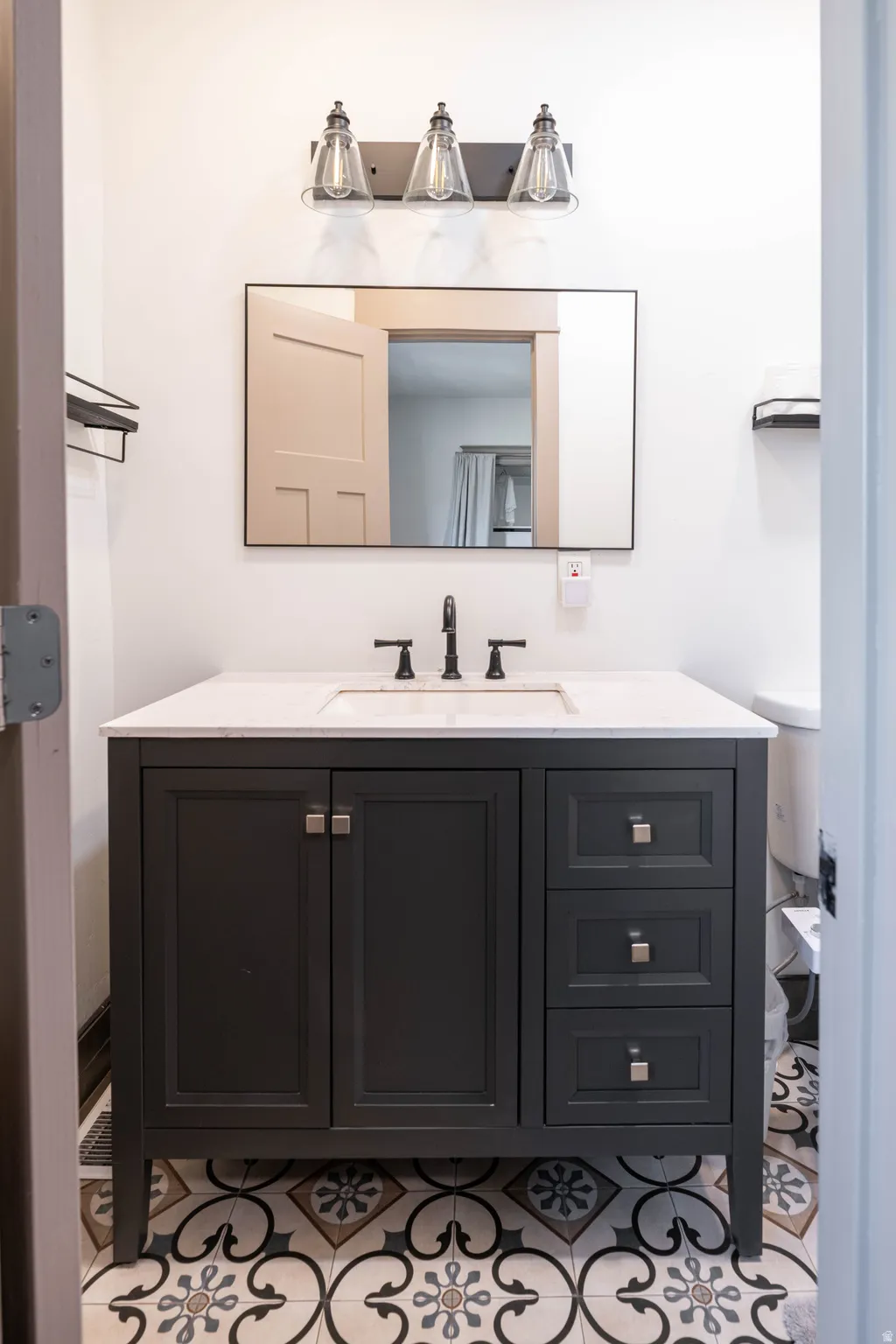 Bathroom with vanity and light tile patterned floors