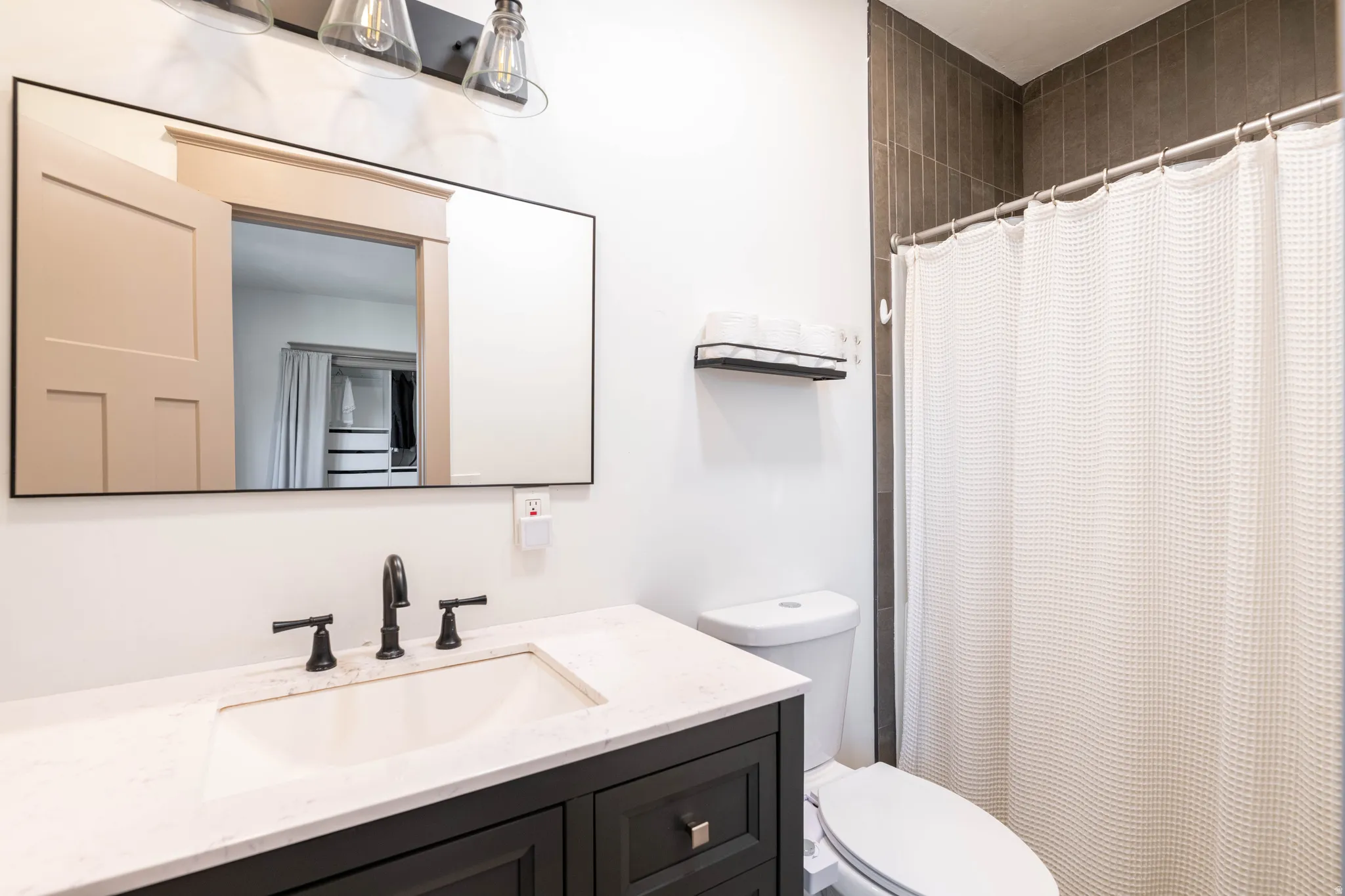 Full bathroom featuring a shower with shower curtain and vanity