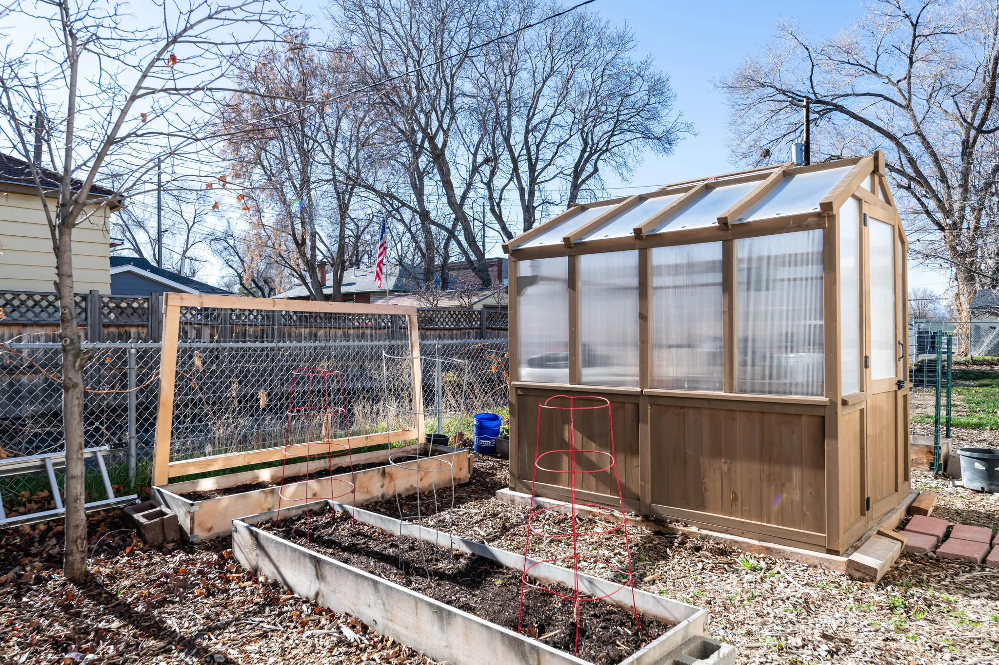 View of yard with a garden, an outbuilding, and a sunroom