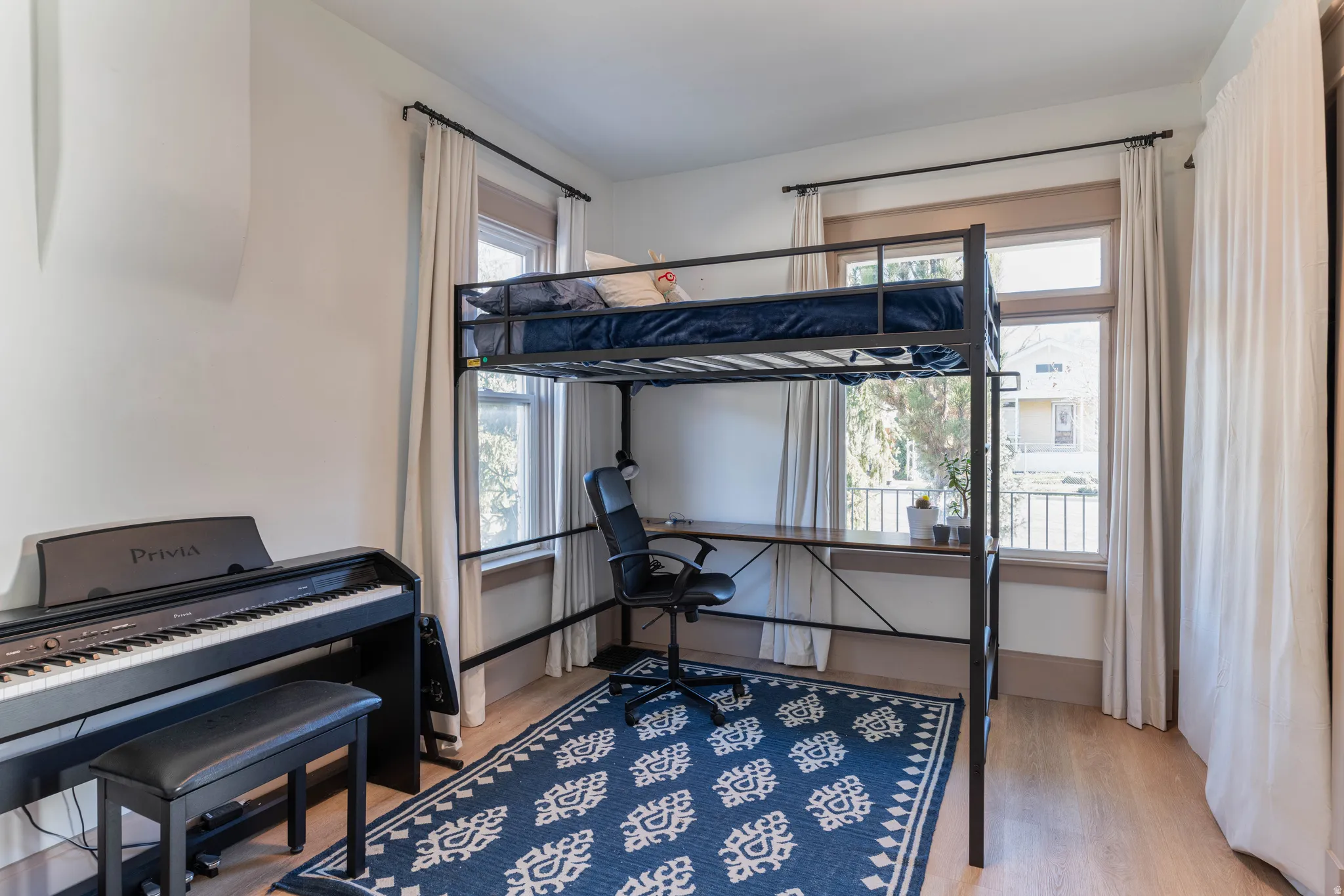 Bedroom featuring light wood-style flooring and baseboards
