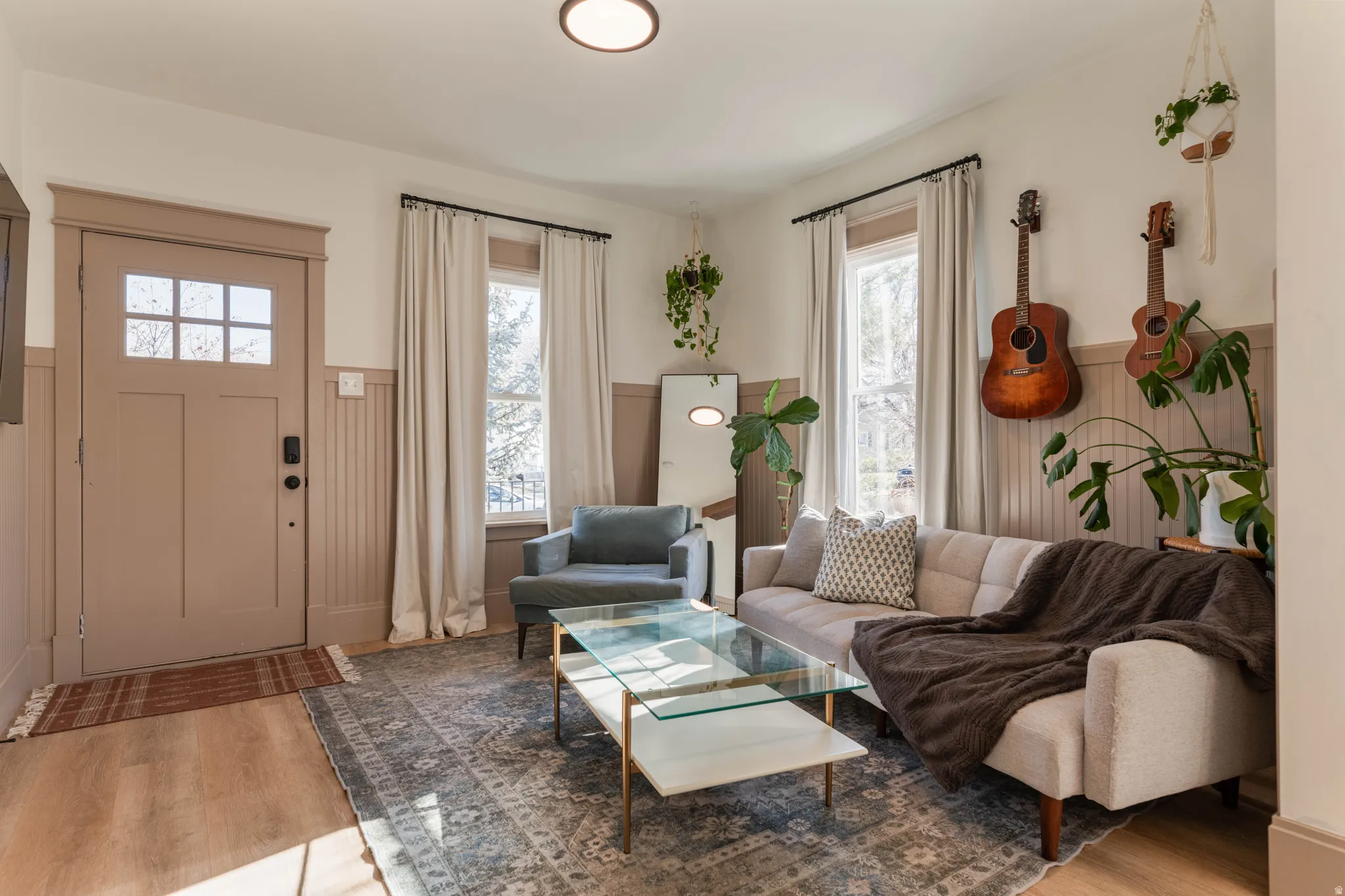 Living room with wainscoting and light wood-type flooring