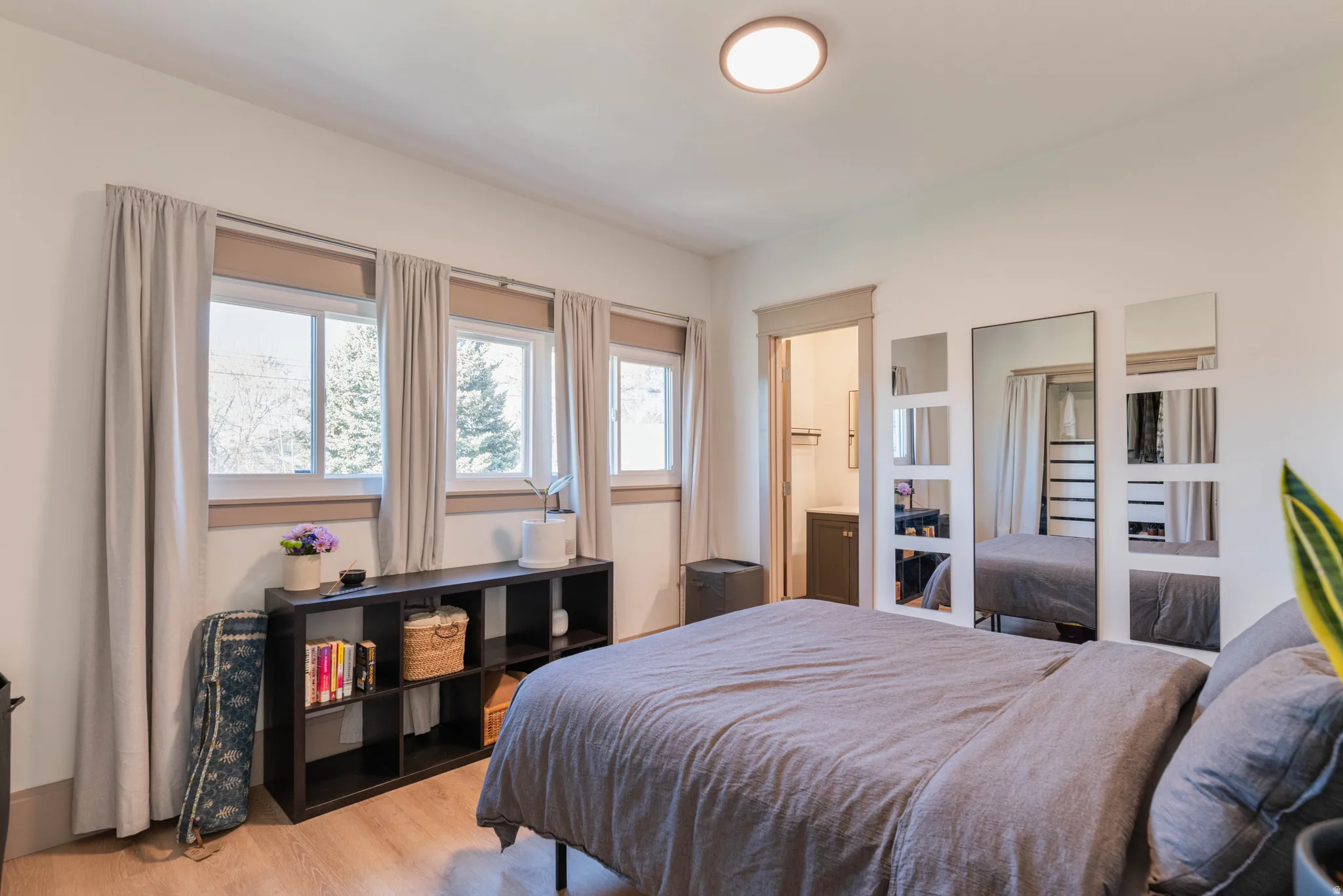 Bedroom featuring light wood-style flooring and ensuite bathroom