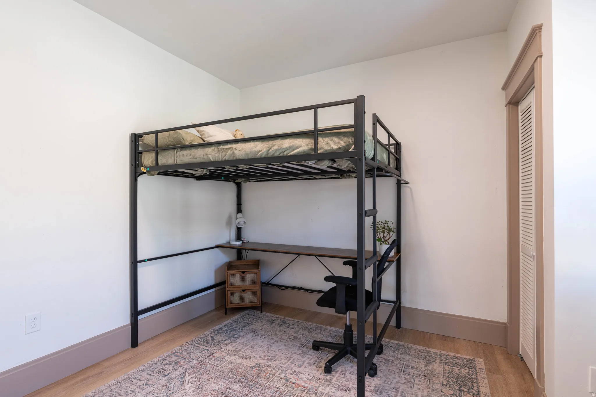 Bedroom featuring light wood-type flooring and baseboards