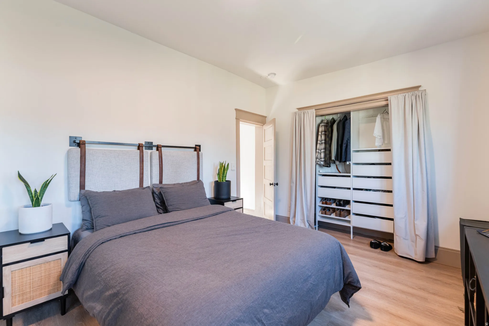 Bedroom featuring light wood-type flooring and baseboards