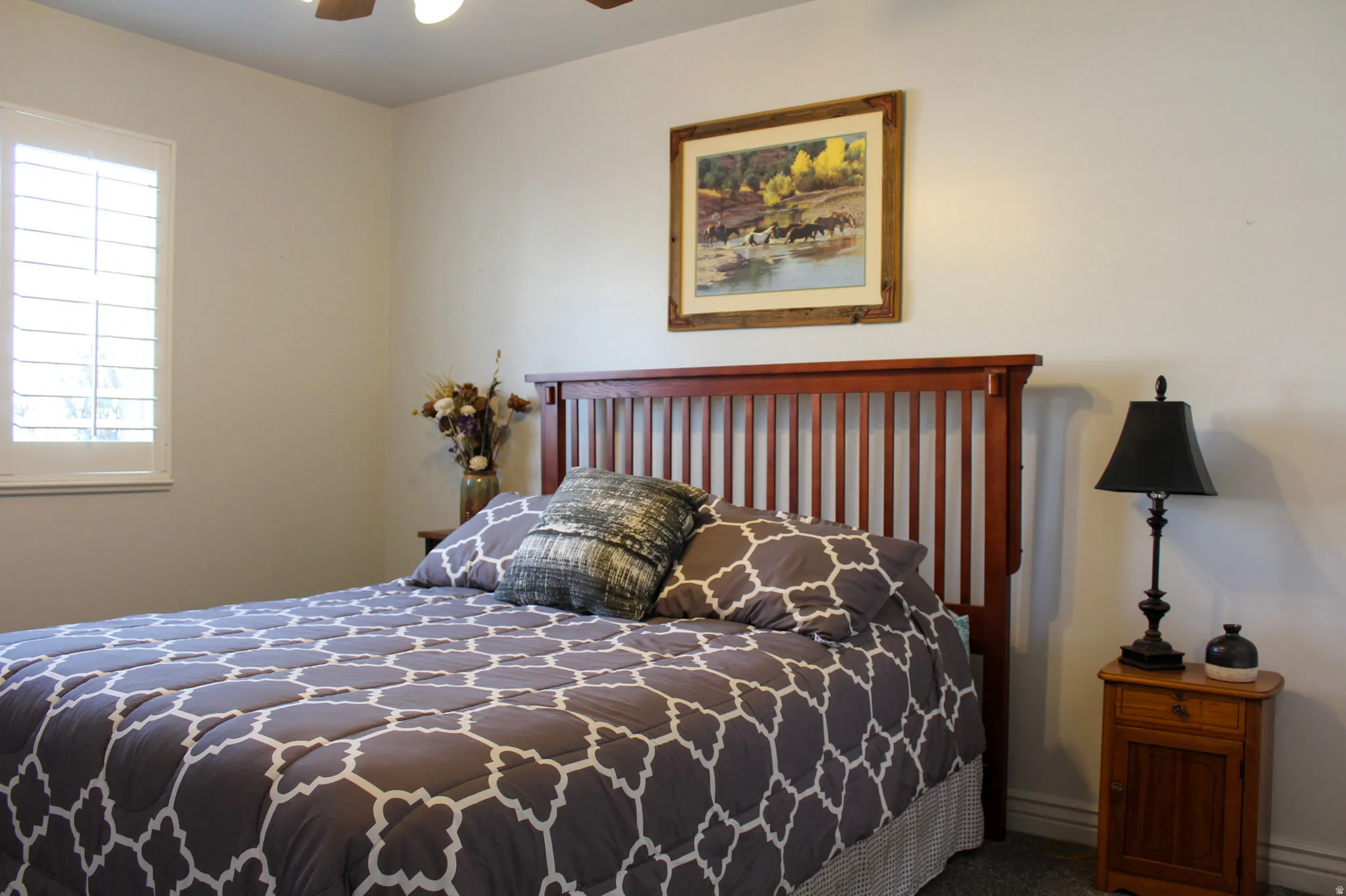 Carpeted bedroom featuring a ceiling fan