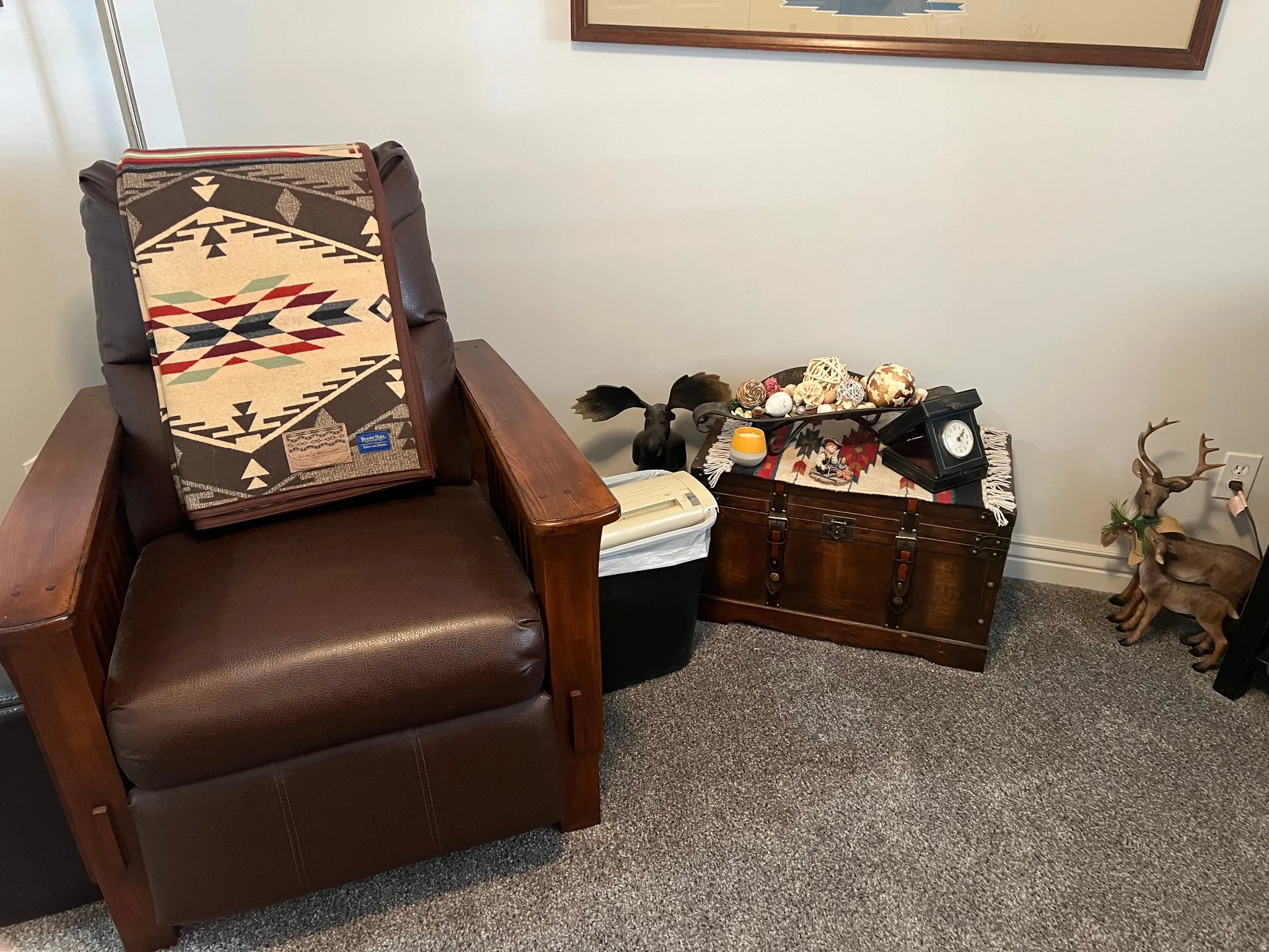 Living area featuring dark colored carpet and baseboards