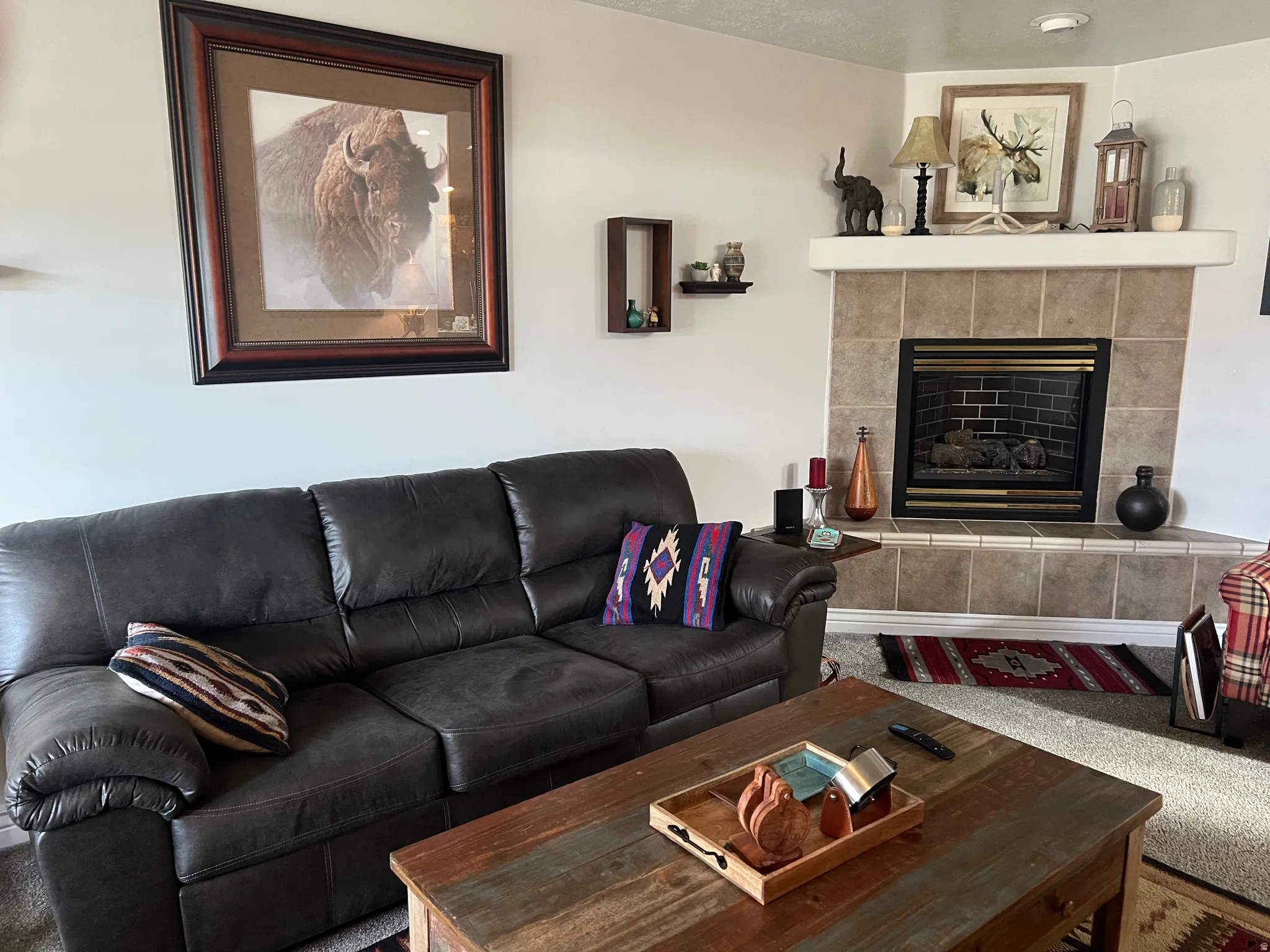 Living room with carpet floors and a fireplace