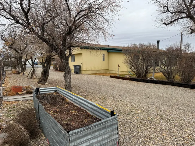 View of side of home featuring a garden