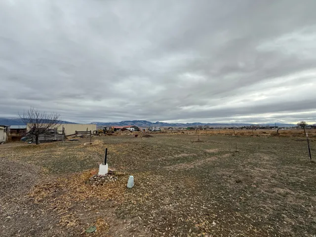 View of yard with a rural view and a mountain view