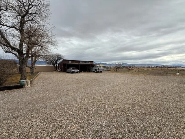 View of yard with a mountain view and driveway