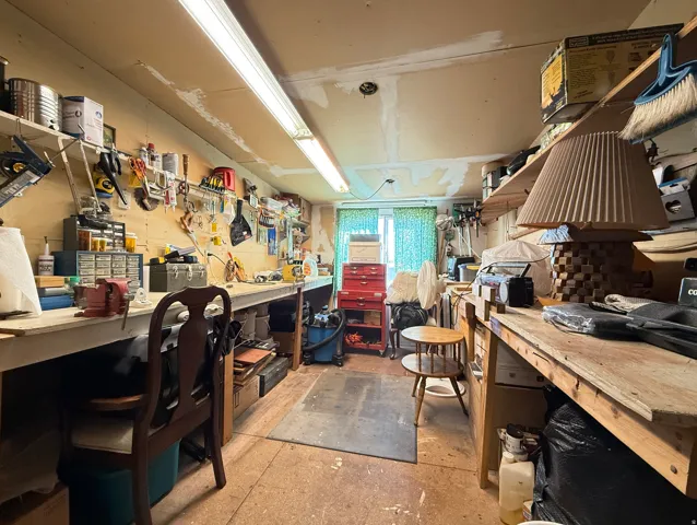 Misc room featuring a workshop area and concrete floors
