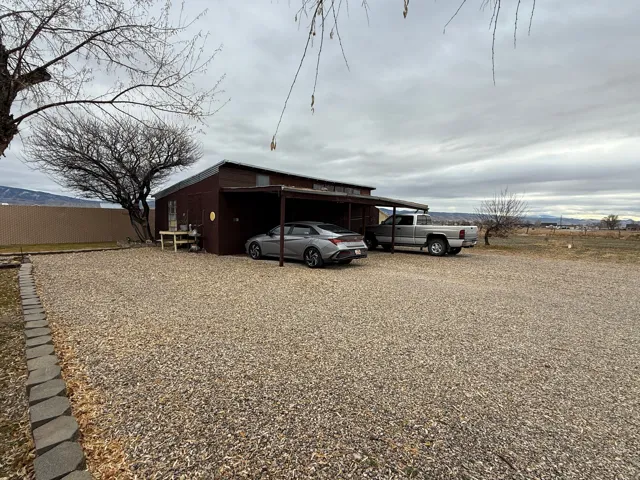 View of outdoor structure with a carport