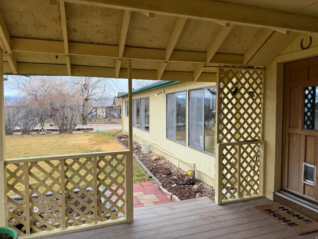 Wooden terrace with a lawn
