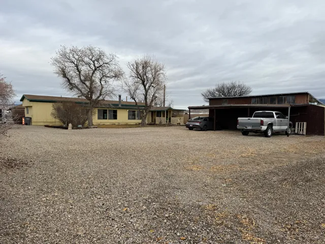 View of front of house with a carport and driveway