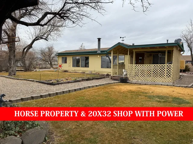 View of front of house with a front yard and a deck