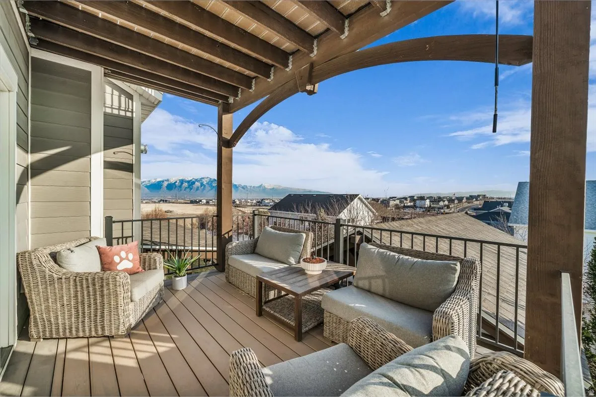Wooden deck featuring outdoor seating and a mountain view