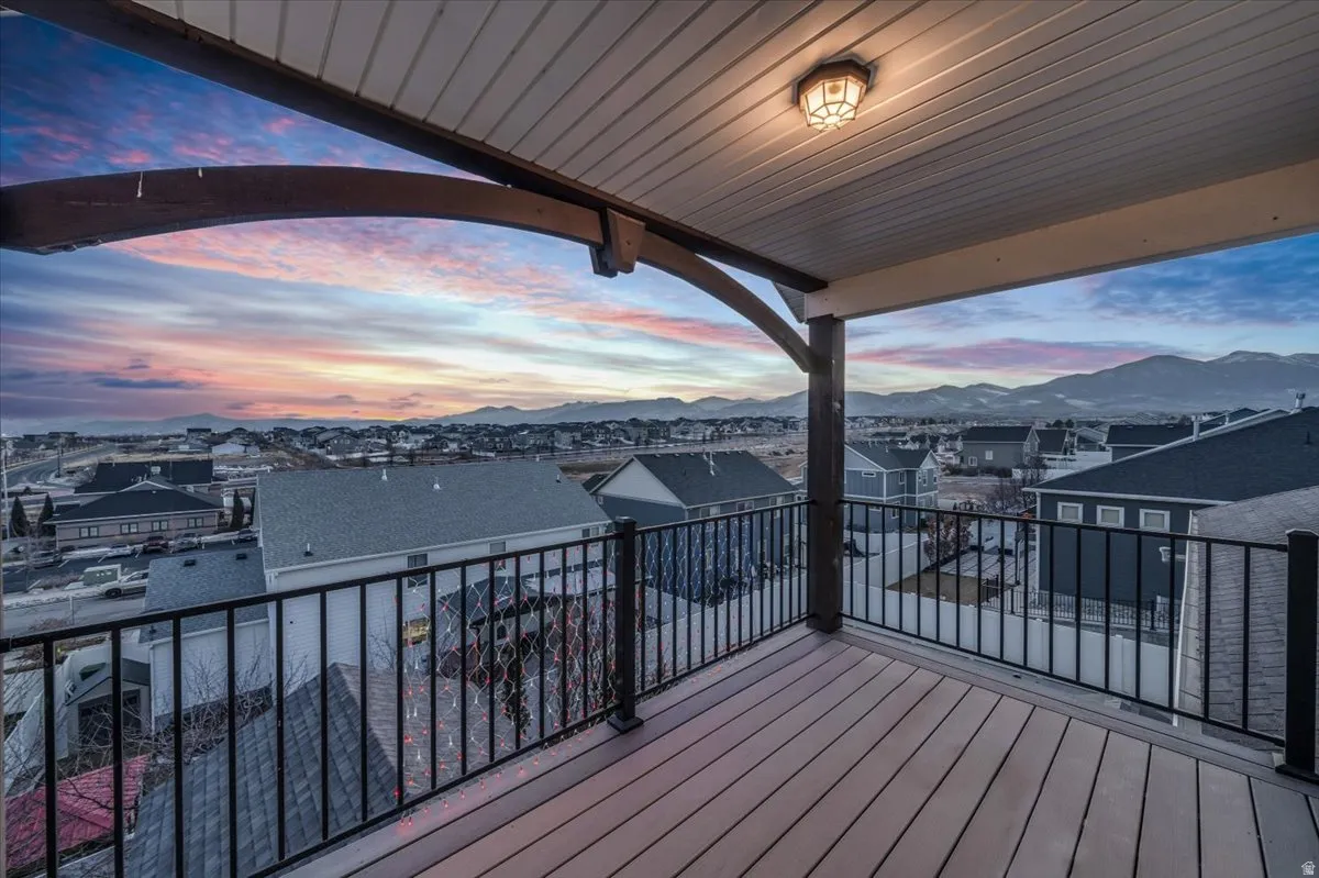 Deck with a residential view and a mountain view