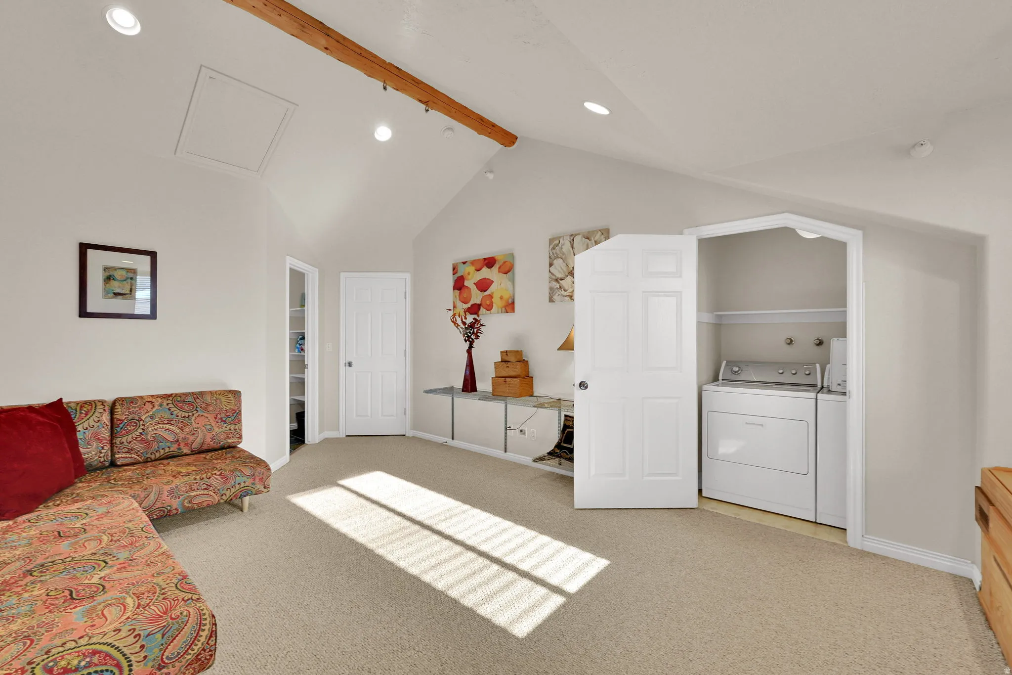 Master bedroom featuring light carpet, washing machine and dryer, and recessed lighting