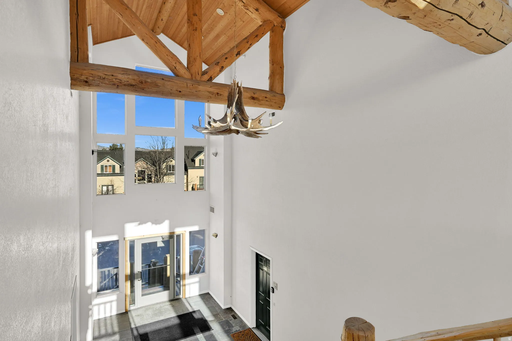 Interior space featuring a vaulted wood ceiling and a chandelier