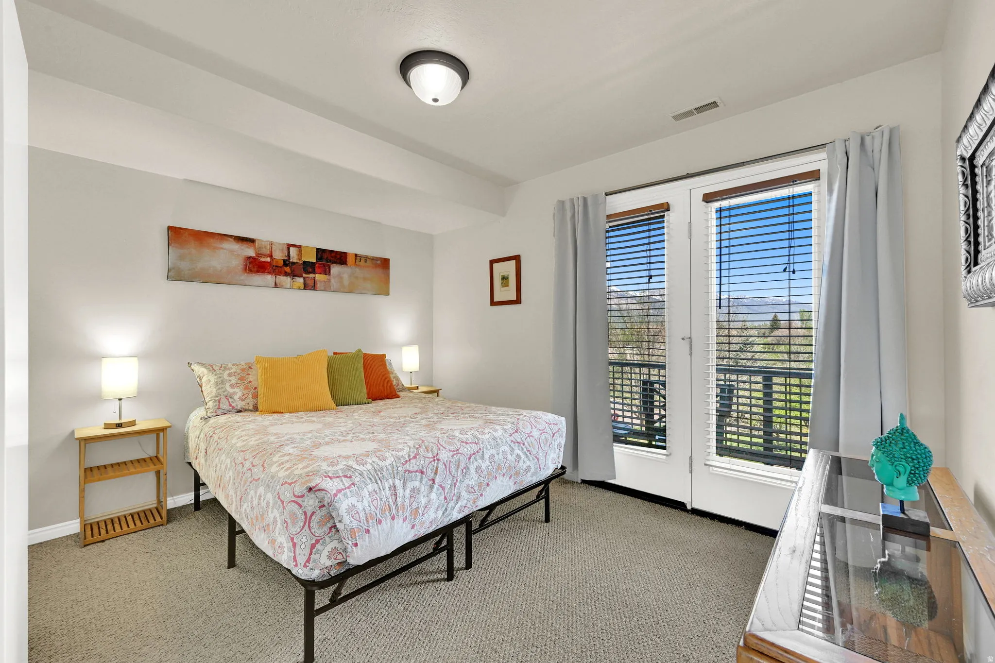 Bedroom featuring light gray wall paint and neutral carpeting