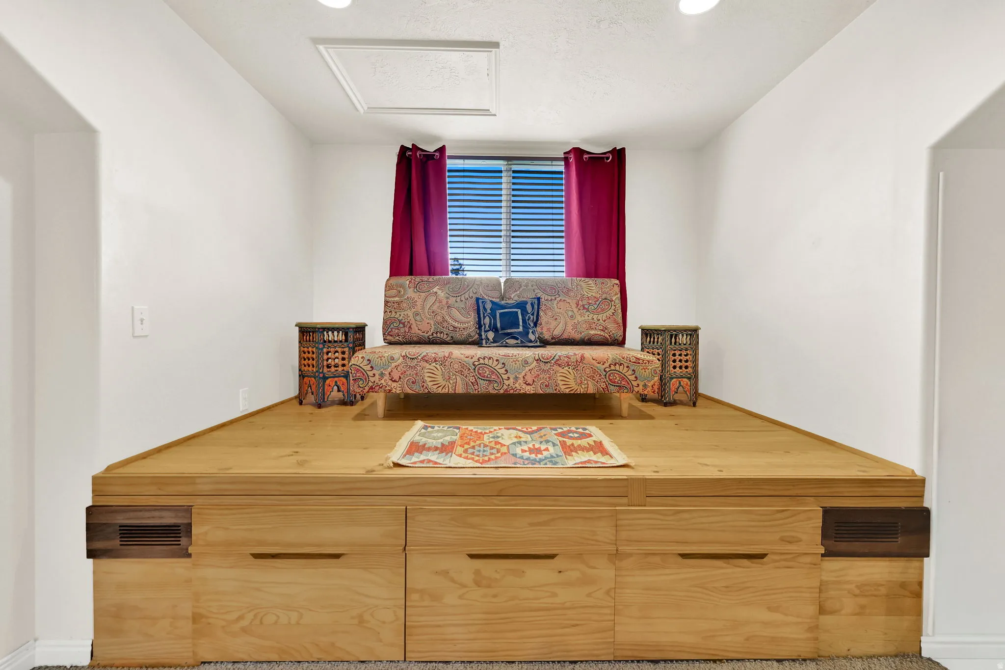 Elevated platform featuring light wood-finish construction with integrated storage drawers