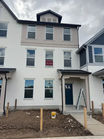 View of front of home featuring stucco siding and covered porch