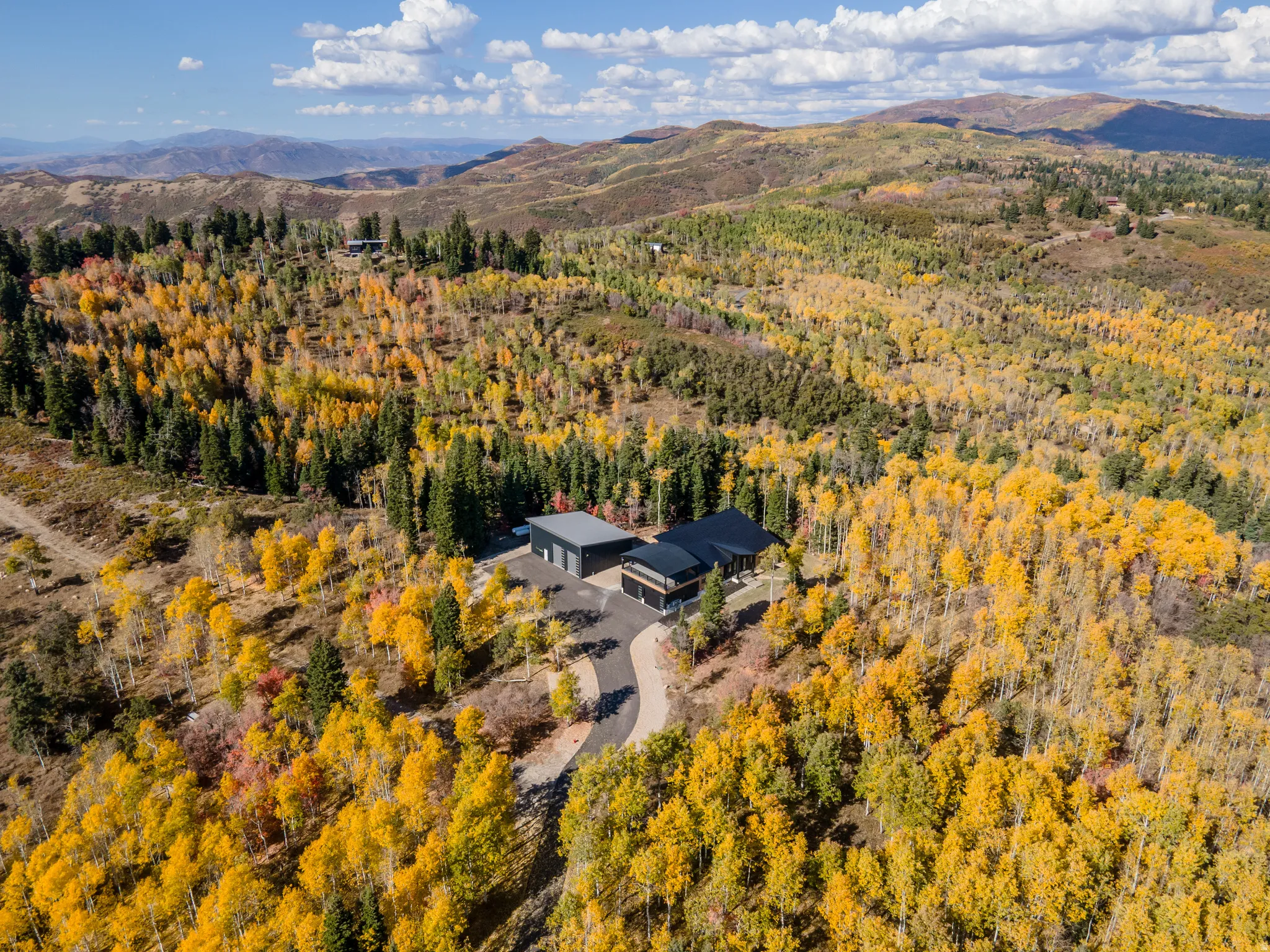 Aerial overview of property's location featuring a mountainous background