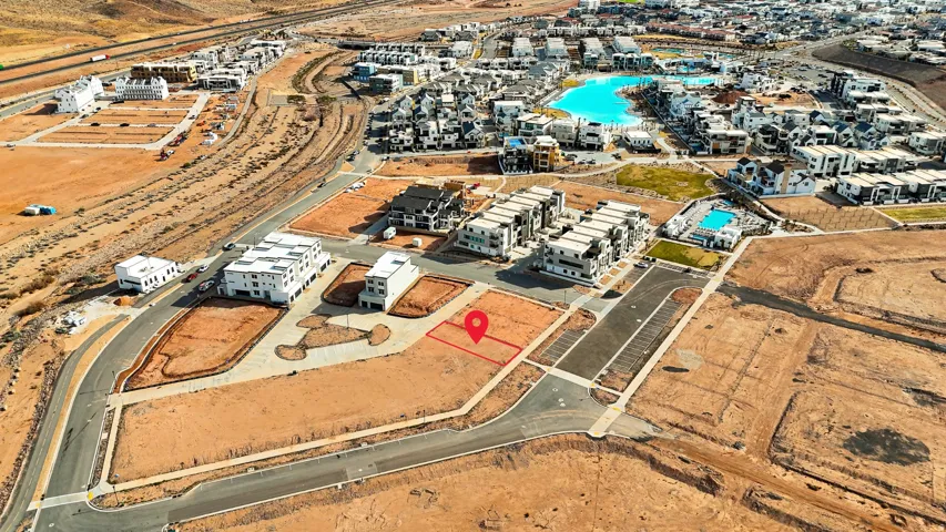 Aerial view of property and surrounding area featuring a pool area
