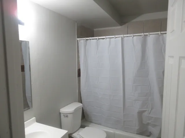 Bathroom with vanity and shower / tub combo