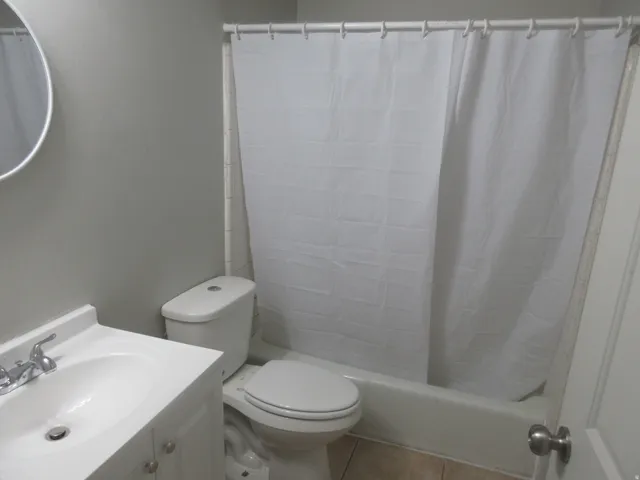 Full bath featuring vanity, tile patterned floors, and shower / bath combo