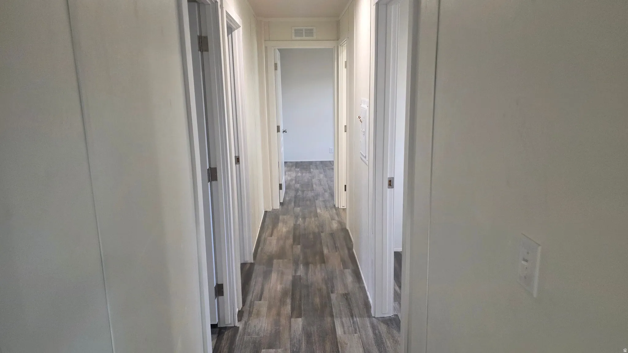 Hall featuring dark wood finished floors
