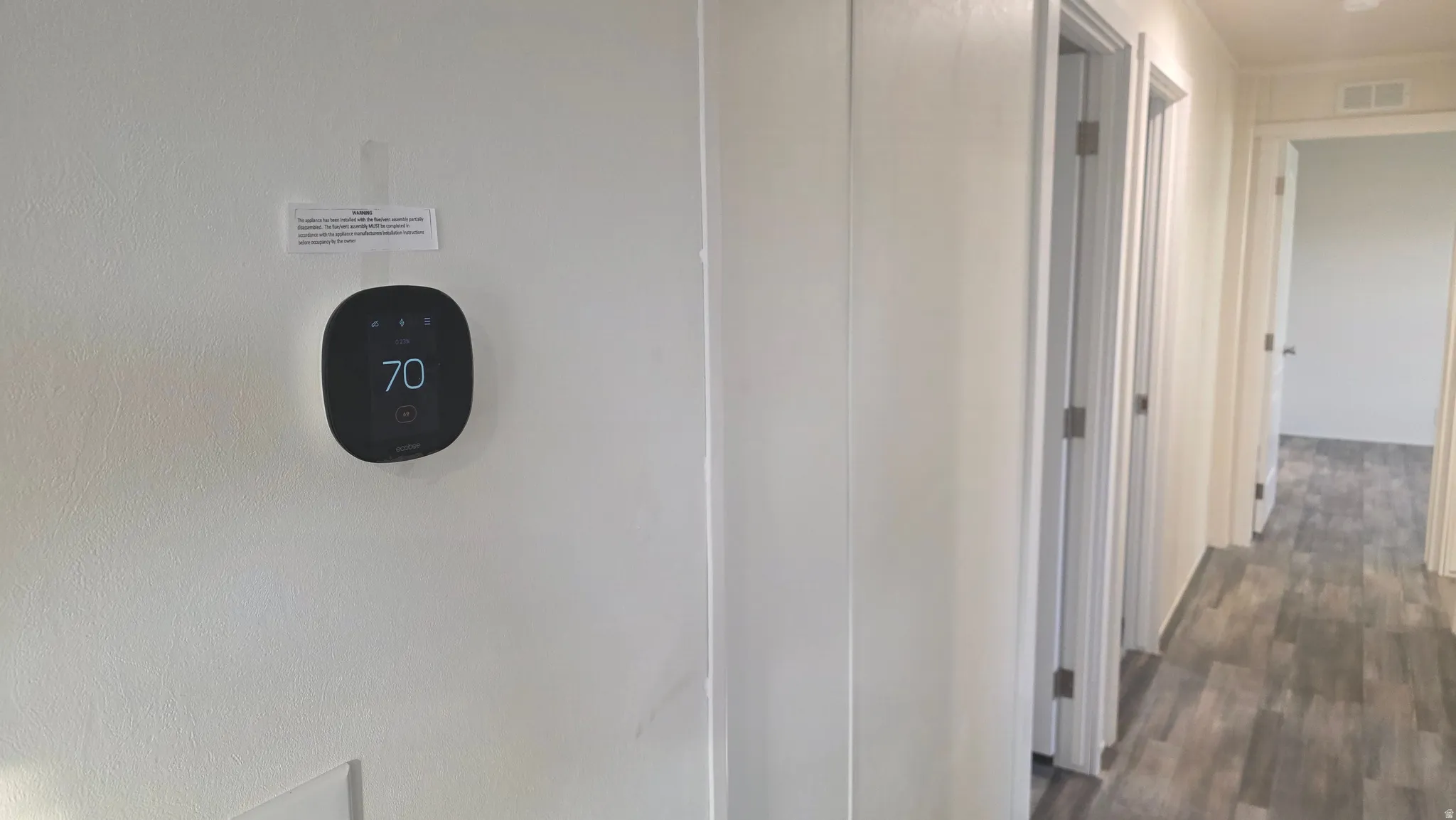 Hallway featuring dark wood-type flooring