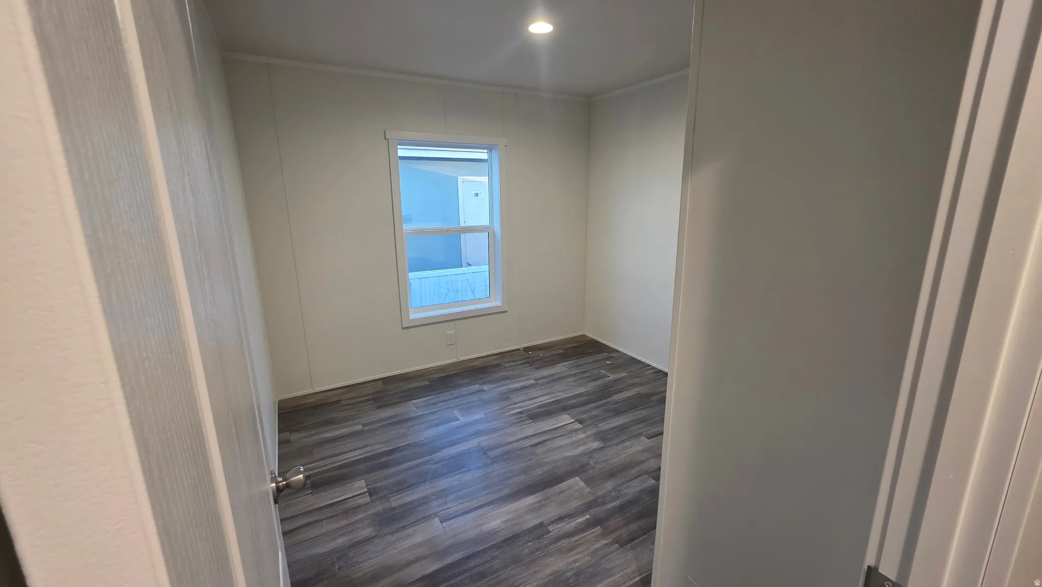 Unfurnished room featuring dark wood-style flooring, recessed lighting, and ornamental molding