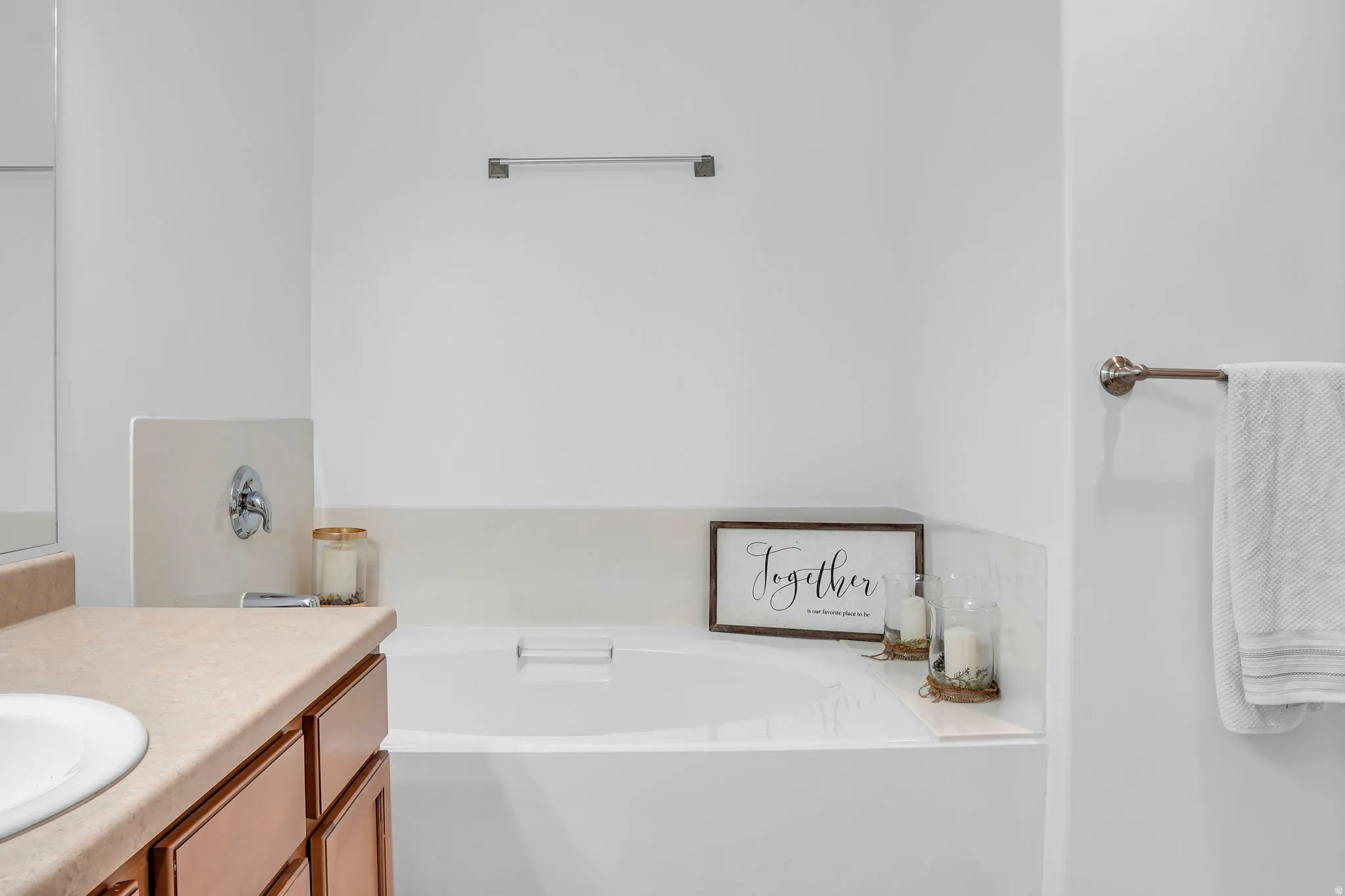Full bath featuring a garden tub and vanity