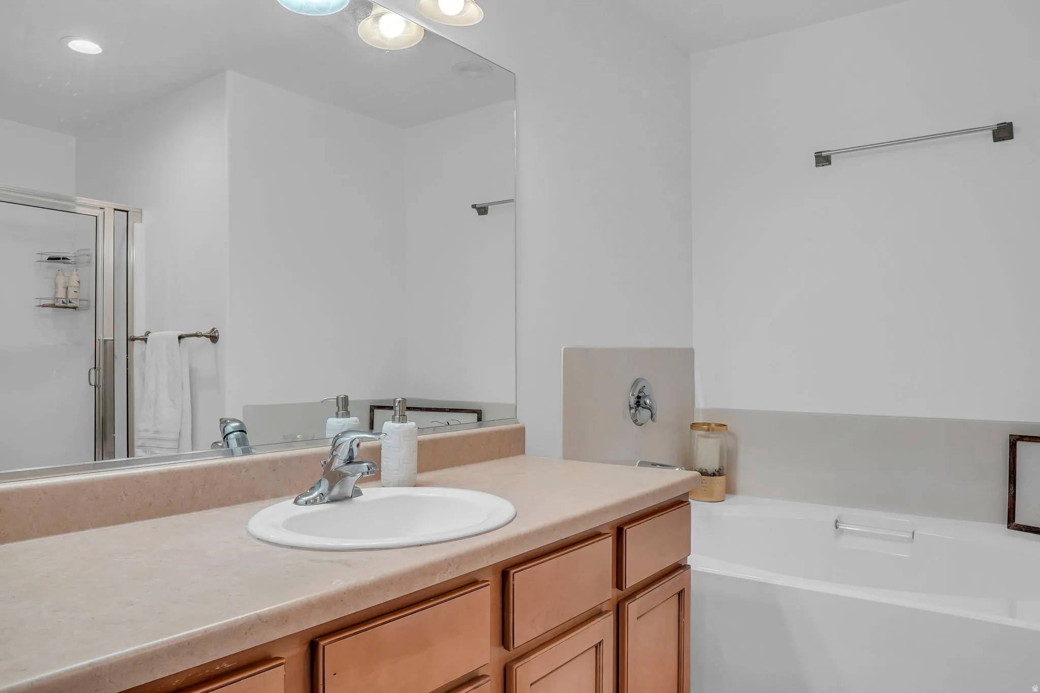 Full bathroom with a garden tub, vanity, and a shower stall