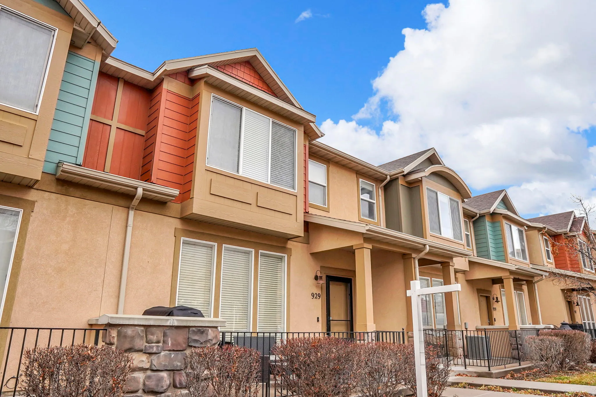 View of front facade with stucco siding, a porch, and a residential view