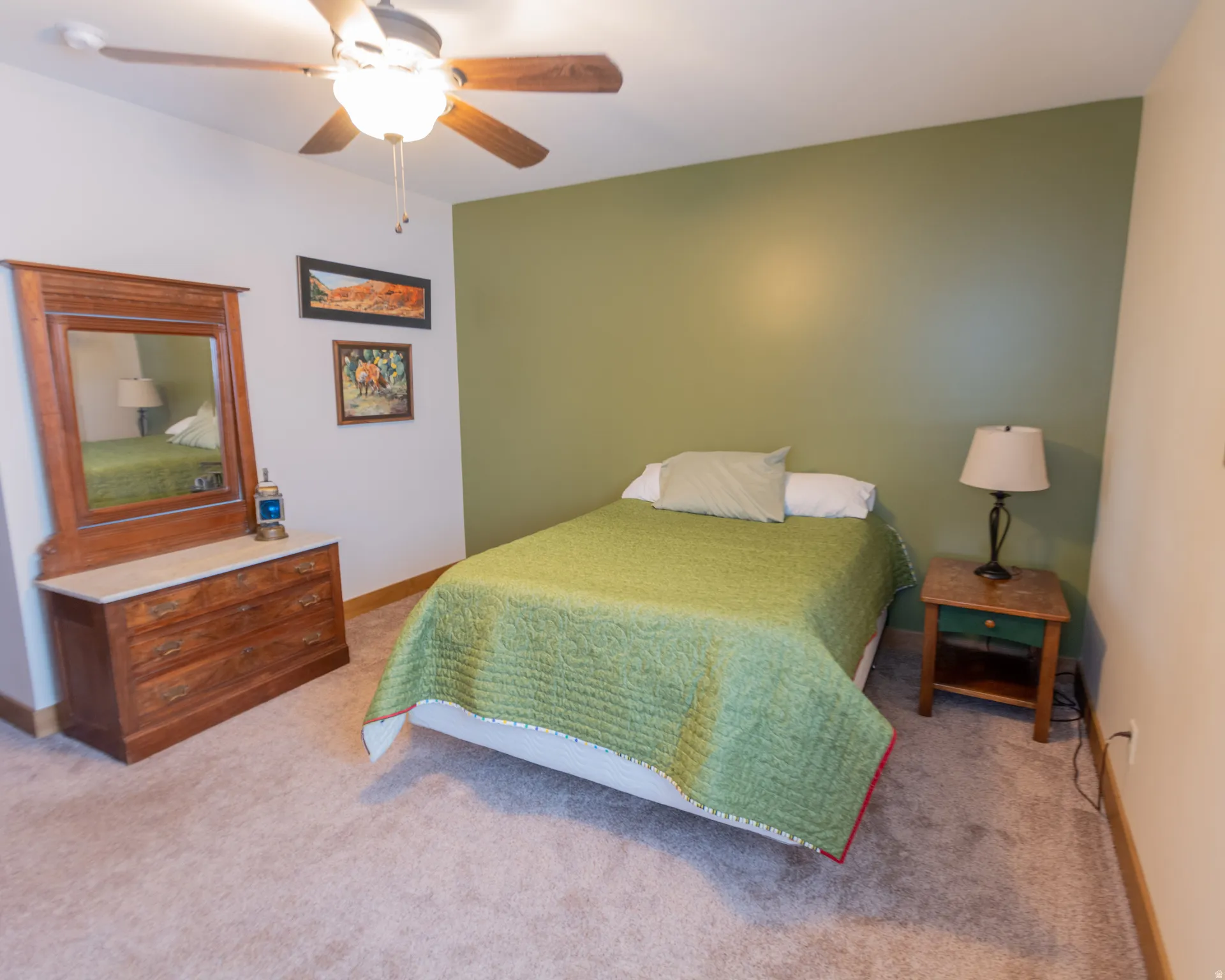 Bedroom with a ceiling fan and light carpet