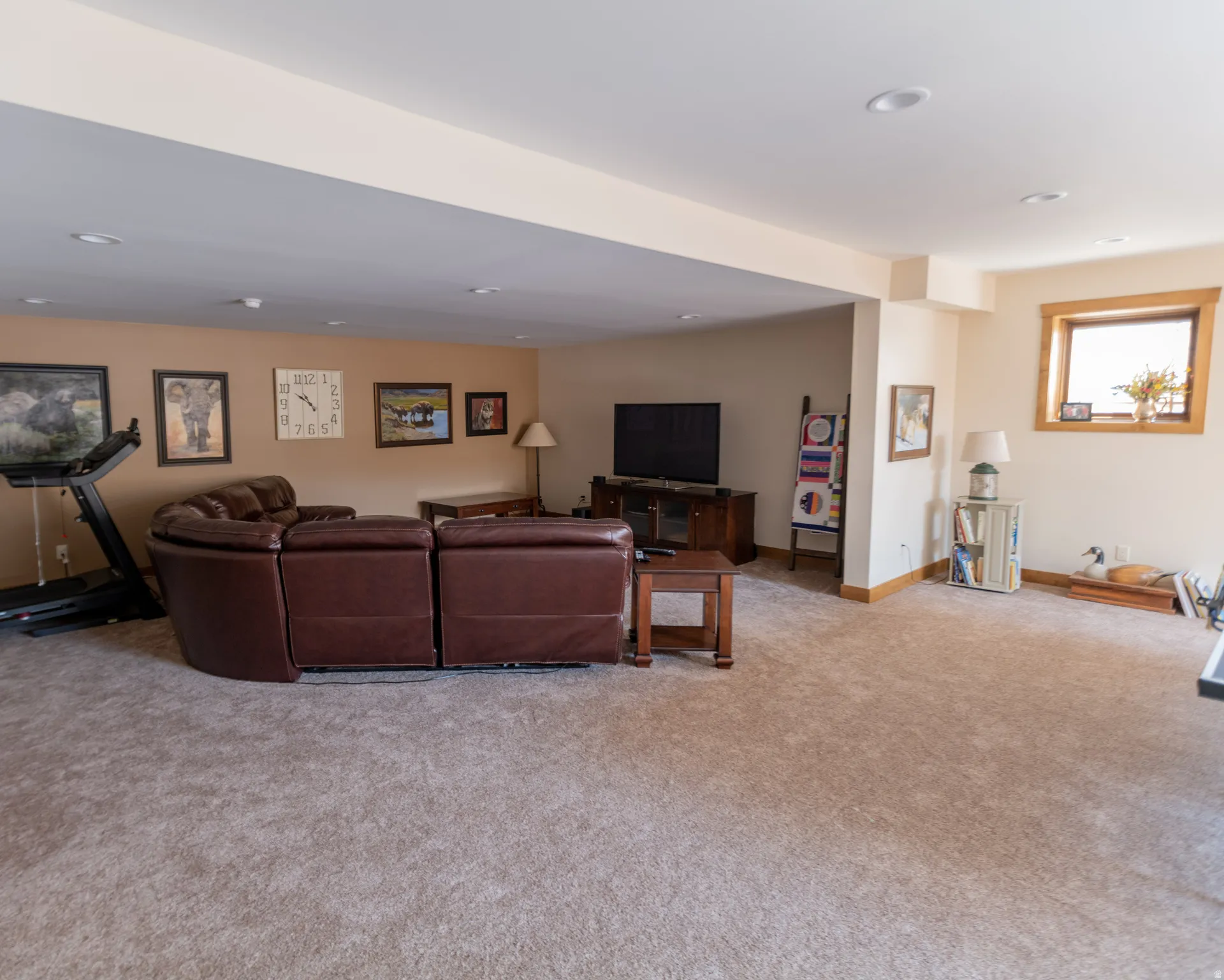 Living area with recessed lighting and light colored carpet