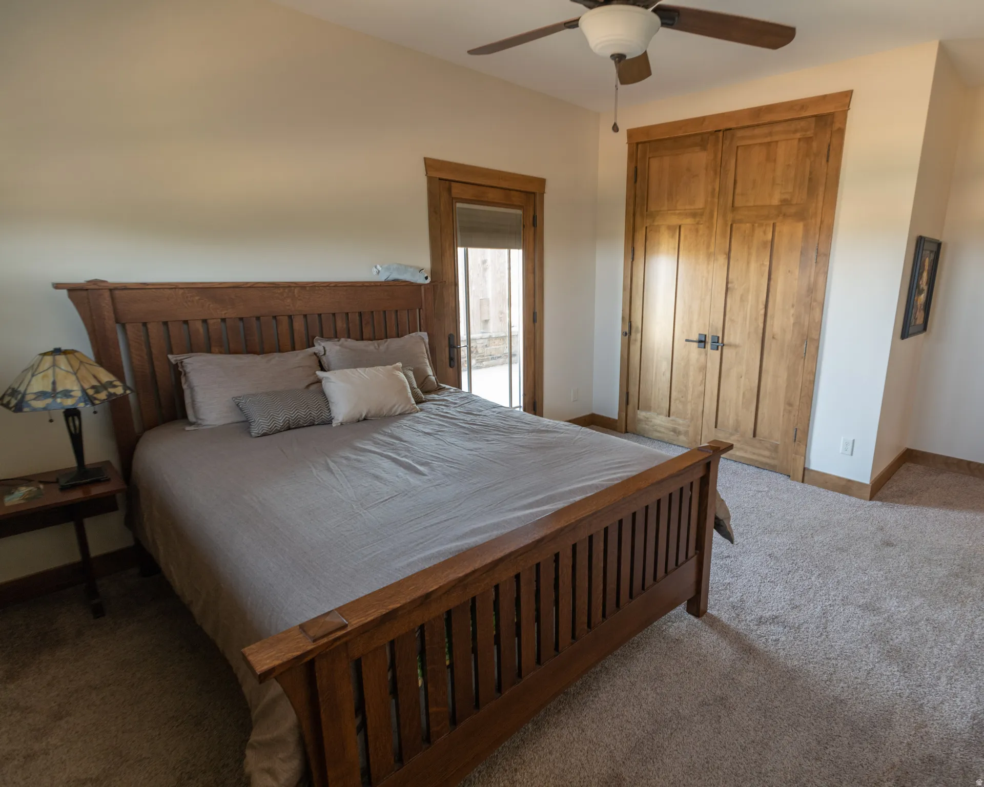 Bedroom with carpet, ceiling fan, and a closet