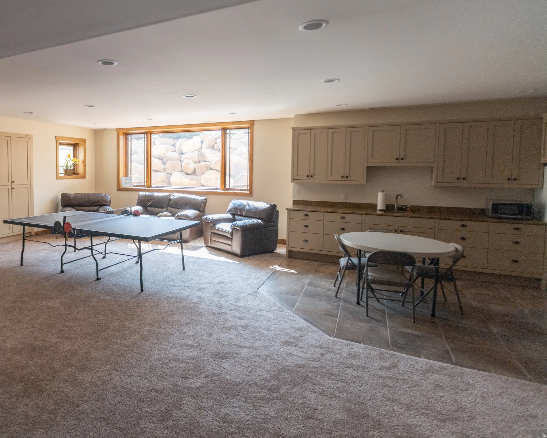 Recreation room featuring light carpet and recessed lighting